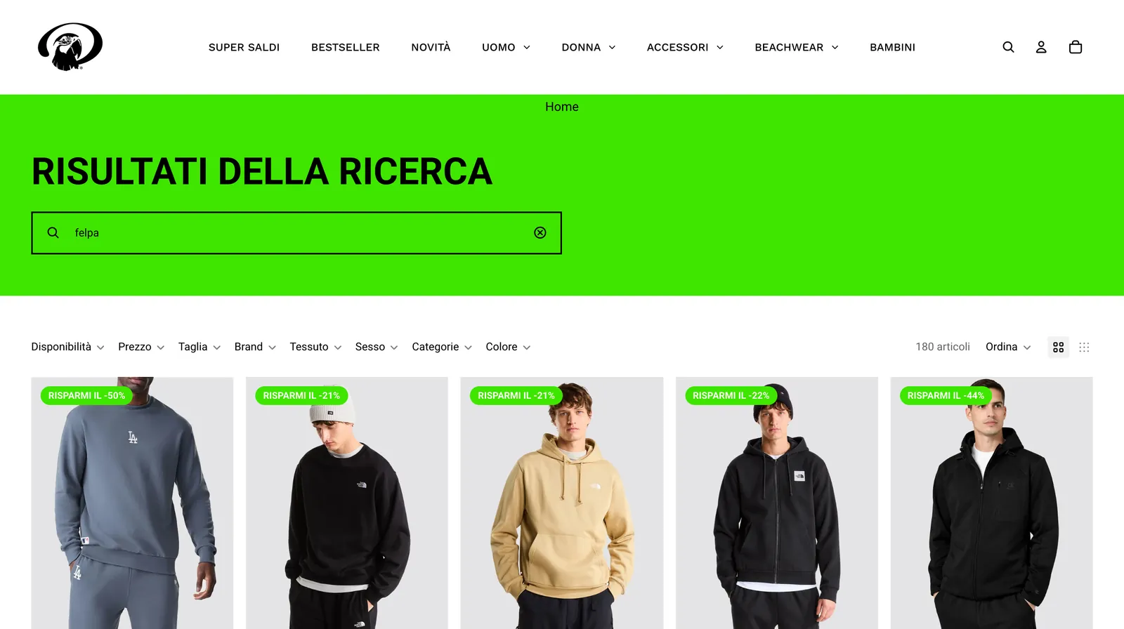La pagina dei risultati di ricerca su desktop: il menu dello store, la fascia verde lime con il titolo e la ricerca «felpa», la barra dei filtri e la prima fila di felpe con i badge degli sconti.